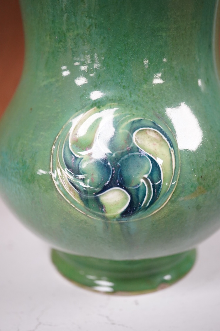 A Moorcroft for Liberty & Co. Flamminion Ware vase, and a smaller Moorcroft vase glazed in a mottled plum flambe, the first 20cm., also to include two Moorcroft reference books